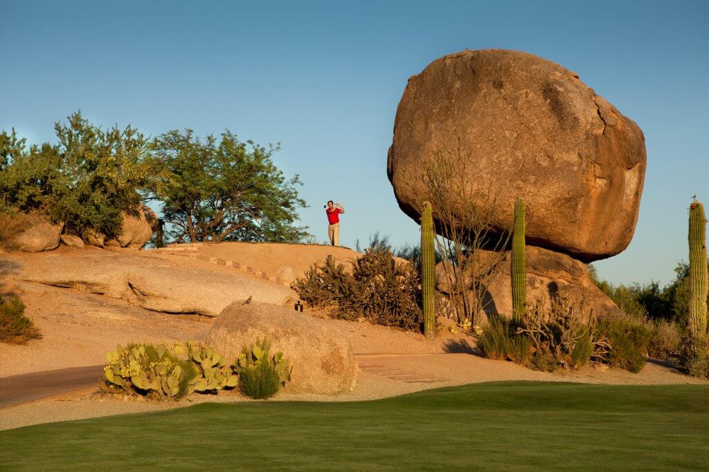 Golfing with a giant boulder in foreground