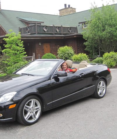 Janet in her car ready to travel