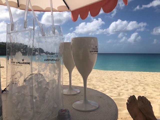 view of the beach and ocean from St Maarten St Martin with umbrella table in foreground