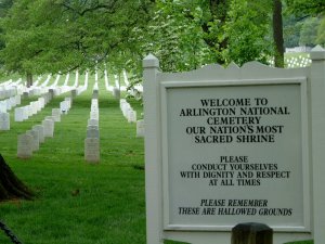 Arlington entrance sign reminds us to honor the fallen. The sign reads "Welcome to Arlington National Cemetary our nation's most sacred shrine. Please conduct yourselves with dignity and respect at all times. Please remember these are hallowed grounds."