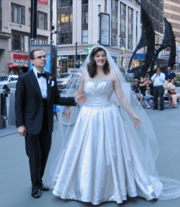 Couple in wedding attire in foreground, New York in Background