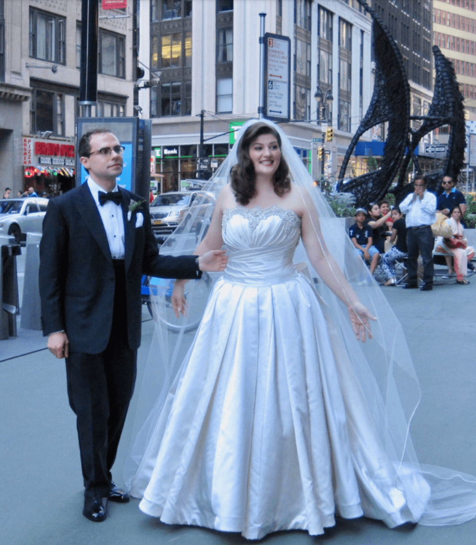 Couple in wedding attire in foreground, New York in Background