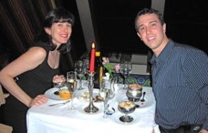 Couple has candlelight dinner on honeymoon cruise