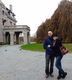 Couple in cold weather clothes standing together in front of Chanler Hotel where they spent their honeymoon