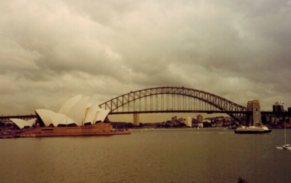 two travel experiences in one picture, the sydney opera house and harbor bridge