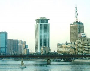 Seen from a boutique riverboat, a felucca sailing the Nile with Cairo in the background