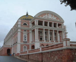 Picture of Manaus Opera house, a large red brick building with marble pillars.
