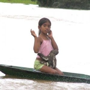 Young girl on canoe in river in Manaus