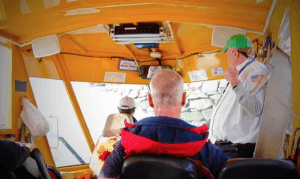 PILOT GUIDES DUCK FROM ROCKY SHORELINE FOR SPLASHDOWN INTO CHARLES RIVER